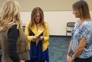 COSF Directors Janna Williams and Marcella Ketelhut talk to presenter Aly Covingtion, on the right.