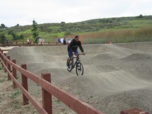 On the pump track. This fellow really should be wearing a helmet.